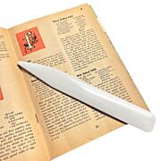 plastic bone folder in use on a vintage book