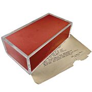 Extra smooth brick in plexiglass weight for conservation, framing or bookbinding is shown holding down fragile old document.